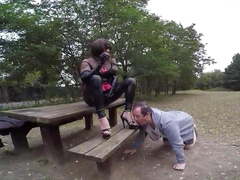 Humiliated licking Mistress boots in a park